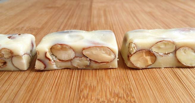 pieces of milk nougat candy with almonds